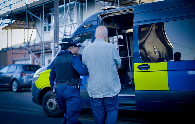 Officers arrest a man on suspicion of violent disorder at an address in Sutton.jpg