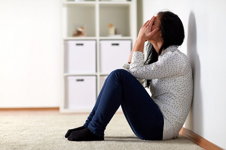 22406510-unhappy-woman-crying-on-floor-at-home