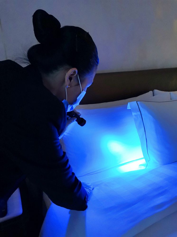 Housekeeping Attendant using the Ultronic UV torch to inspect guest room at PARKROYAL on Beach Road 2.jpg