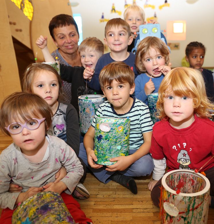 Erzieherin Jutta Linzner freut sich mit den Kindern der Mondgruppe der Hephata-Kita über die gebastelten Laternen.