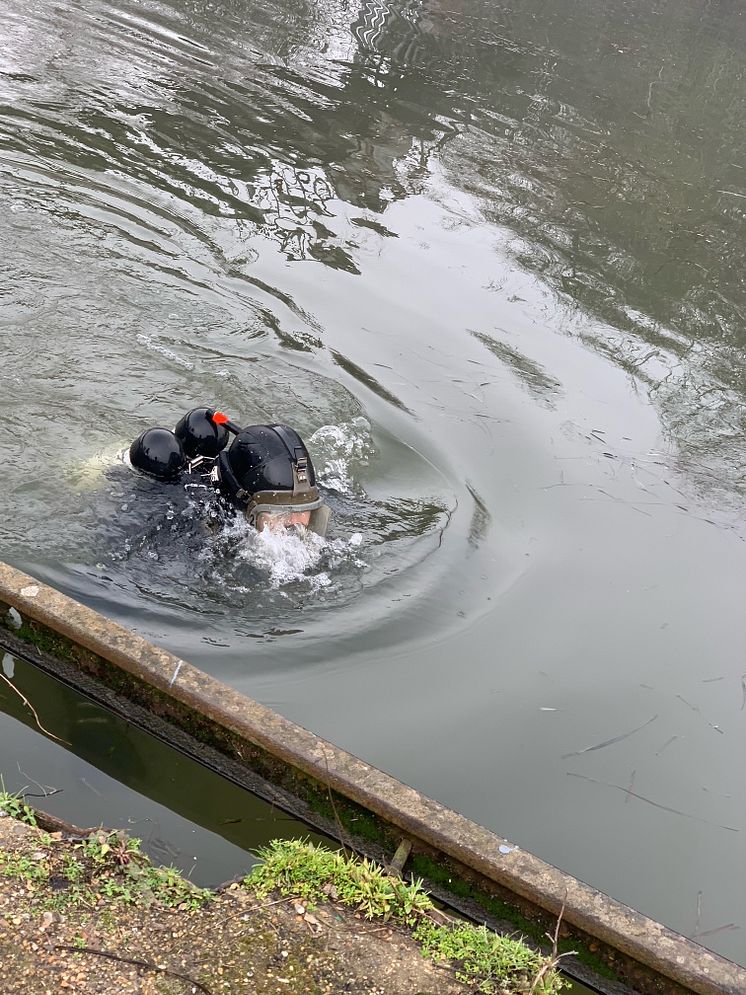 Police diver searching a canal