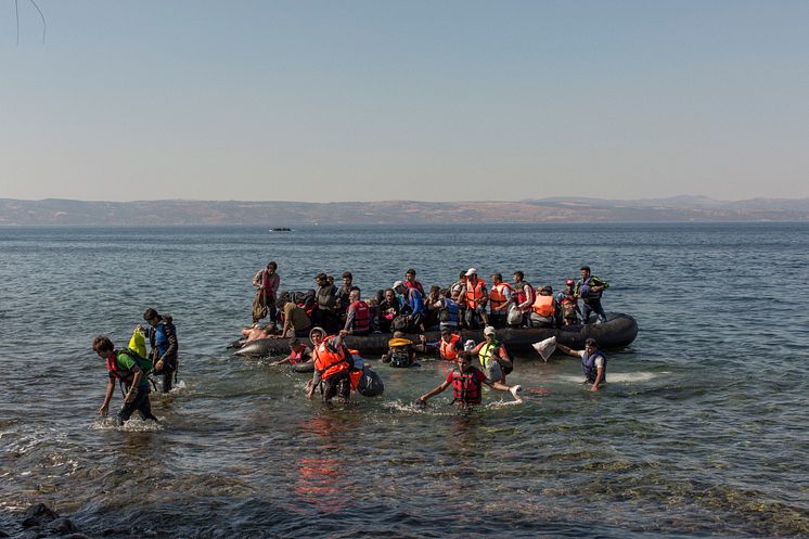 Flyktingar anländer strand