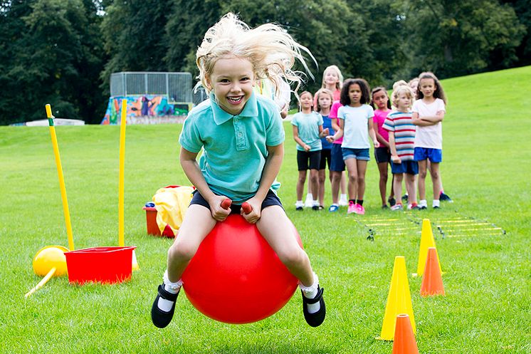 girl playing in school field