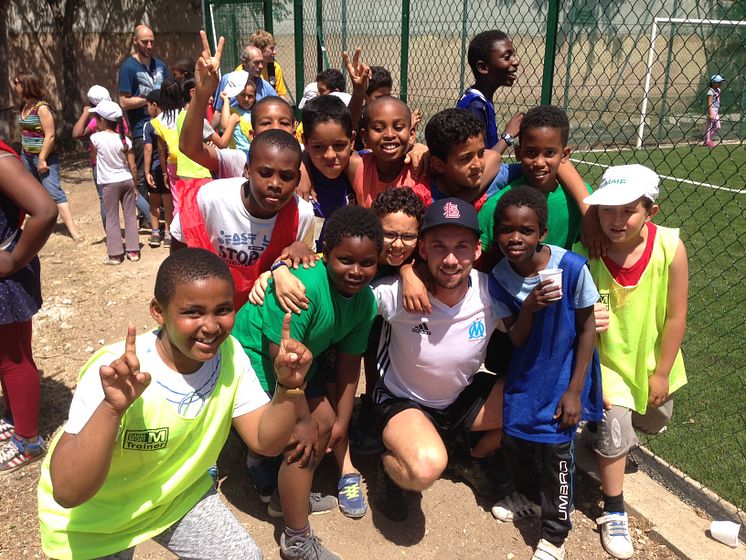 Marco with local children who will benefit from the new community football pitch.