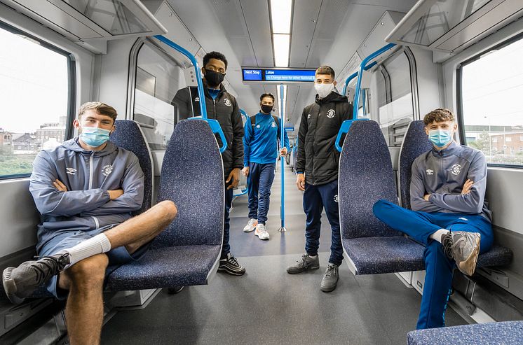 Young Luton Town players wear face masks to and from training