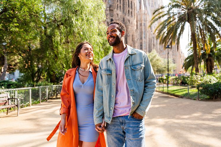 DESR_SPAIN_BARCELONA_SAGRADA-FAMILIA_THEME_COUPLE_HOLDING-HANDS_SMILING-GettyImages-1756019835_Universal_Within usage period_101220.jpg