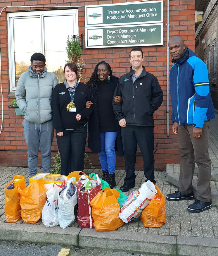 Croydon Community Food Bank volunteers Amatare Oki (far right) and Hakeem Seriki (far left) visited the Selhurst depot with Project Manager Fatima Koroma (middle)