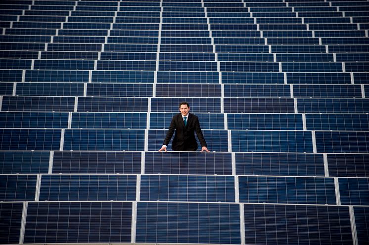 Damon Kent with the solar array on the roof of Sport Central 2 