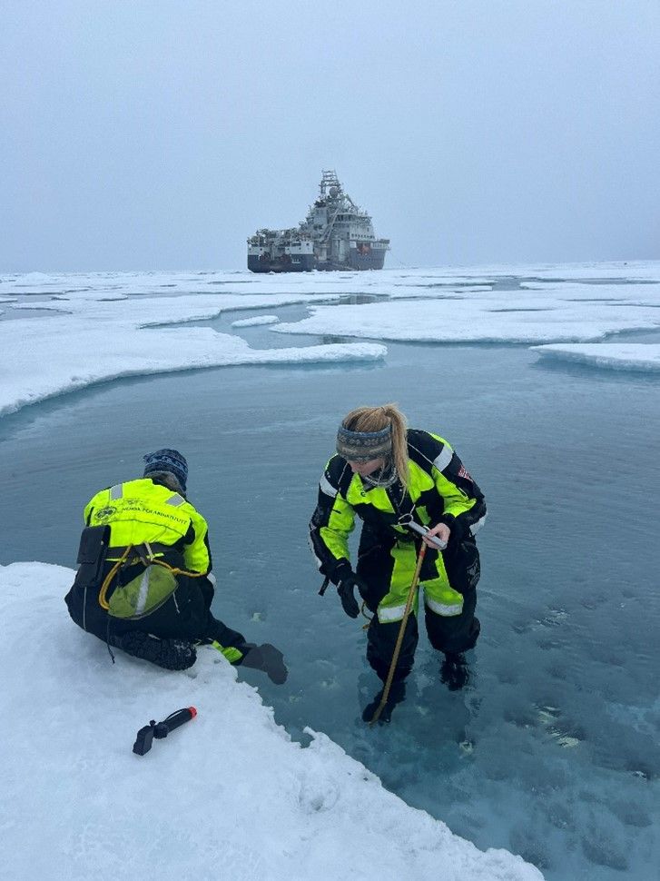 Eva Leu and Rebecca Duncan collecting algae from meltponds for measuring their productivity 
