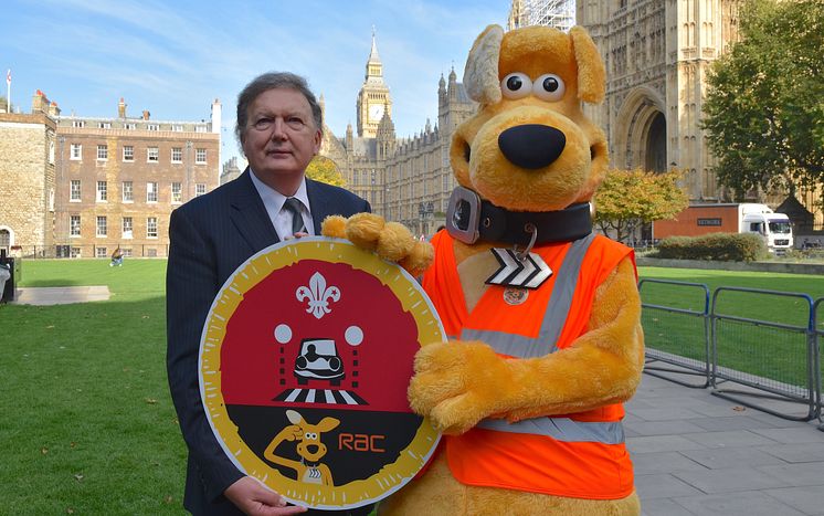 Horace and Sir Greg Knight holding Cubs Road Safety Awareness Champions badge