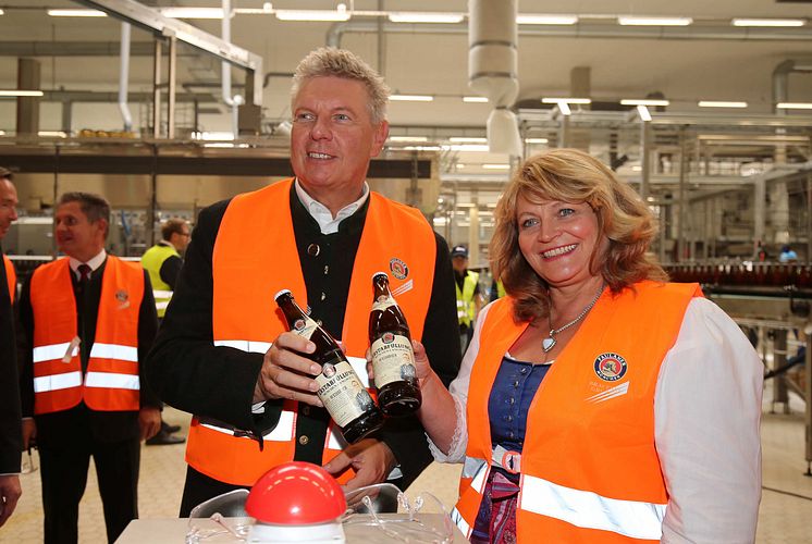 Der Münchner Oberbürgermeister Dieter Reiter und Alexandra Schörghuber mit den beiden ersten in München-Langwied abgefüllten Flaschen Paulaner Bier