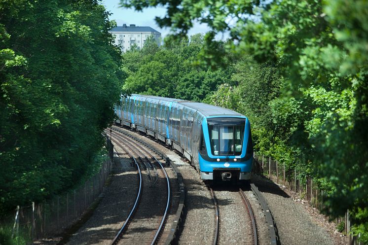Tunnelbanetåg i sommargrönska