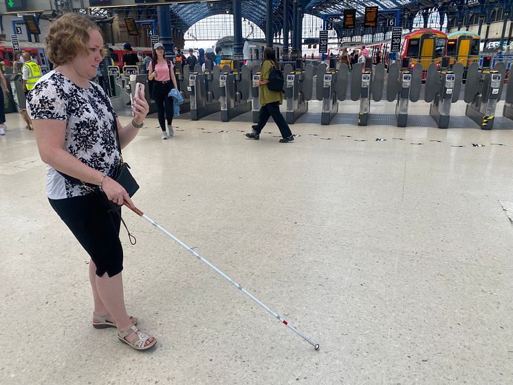 Linn Davies is guided through Brighton station using the Aira app