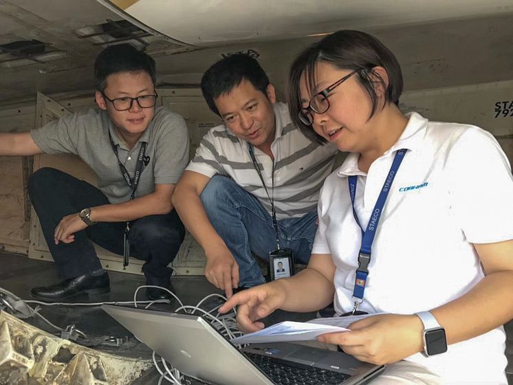 Hi-res image - Cobham SATCOM -  Cobham sales engineer Ying Cui helps configure the AVIATOR 300D terminal with Shenzhen Airlines
