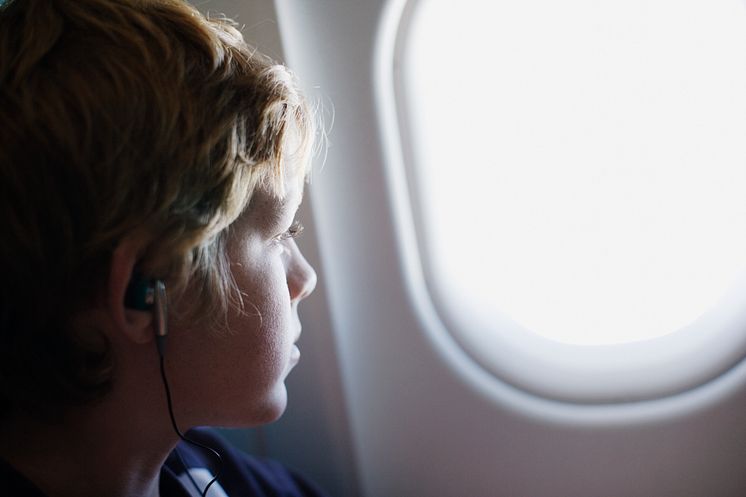 A child looking out his airplane window