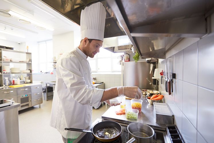 22688496-happy-male-chef-cooking-food-at-restaurant-kitchen