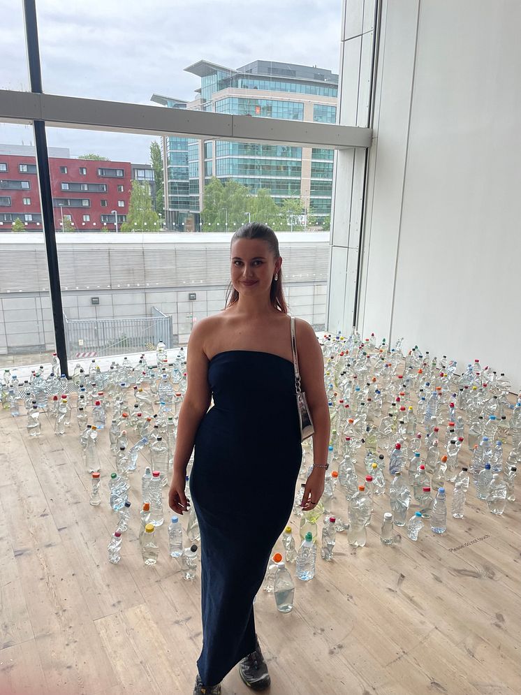 Northumbria University graduate Alice Kershaw pictured with her work, Discarded Bottles