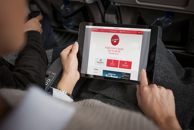 Passenger using Norwegian's free WiFi. 