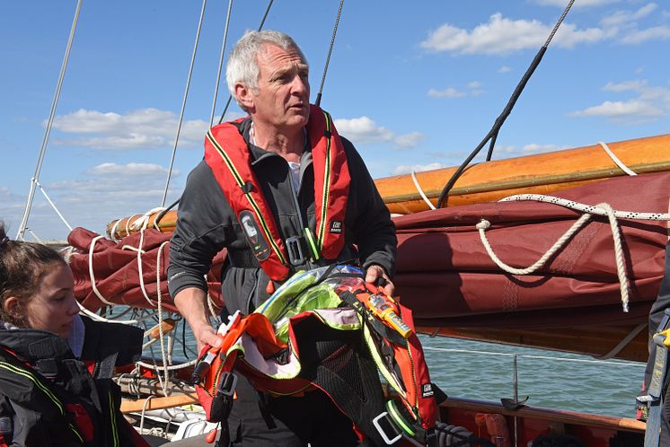 Hi-res image - Ocean Signal - Head of Sailing at Dauntsey’s Toby Marris briefs the Jolie Brise crew about the Ocean Signal rescueME MOB1