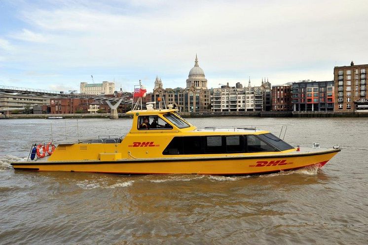 DHL Express riverboat on river with St Pauls.jpg