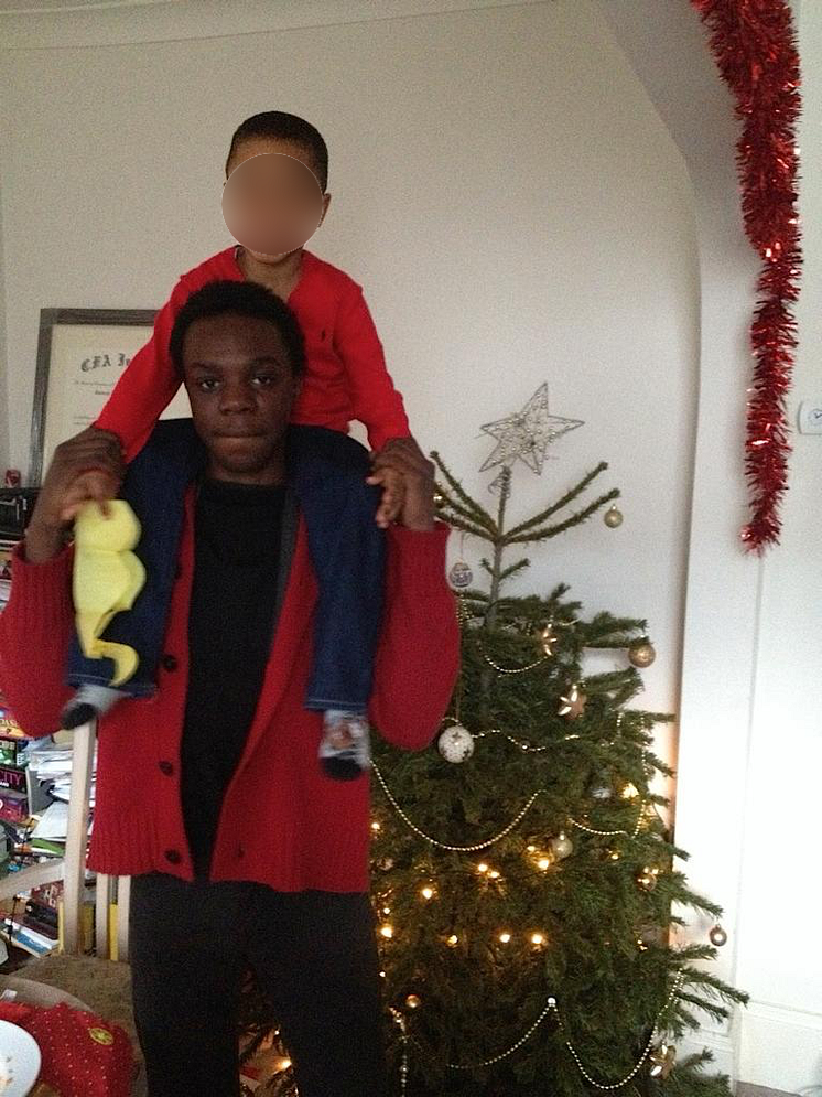 Ola with a child on his shoulders.png