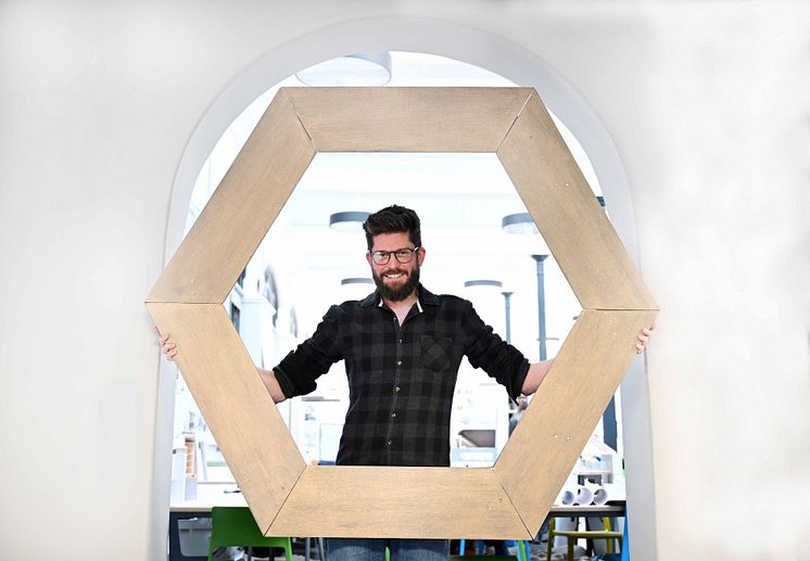 Dr Henrik Melin pictured with a life-sized replica of one of the Webb telescope’s 18 individual hexagonal mirrored panels.jpg