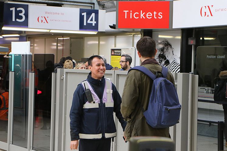 Portal - Customer Service Host Antonio Tapia welcomes a passenger at the Gatwick Express portal at London Victoria