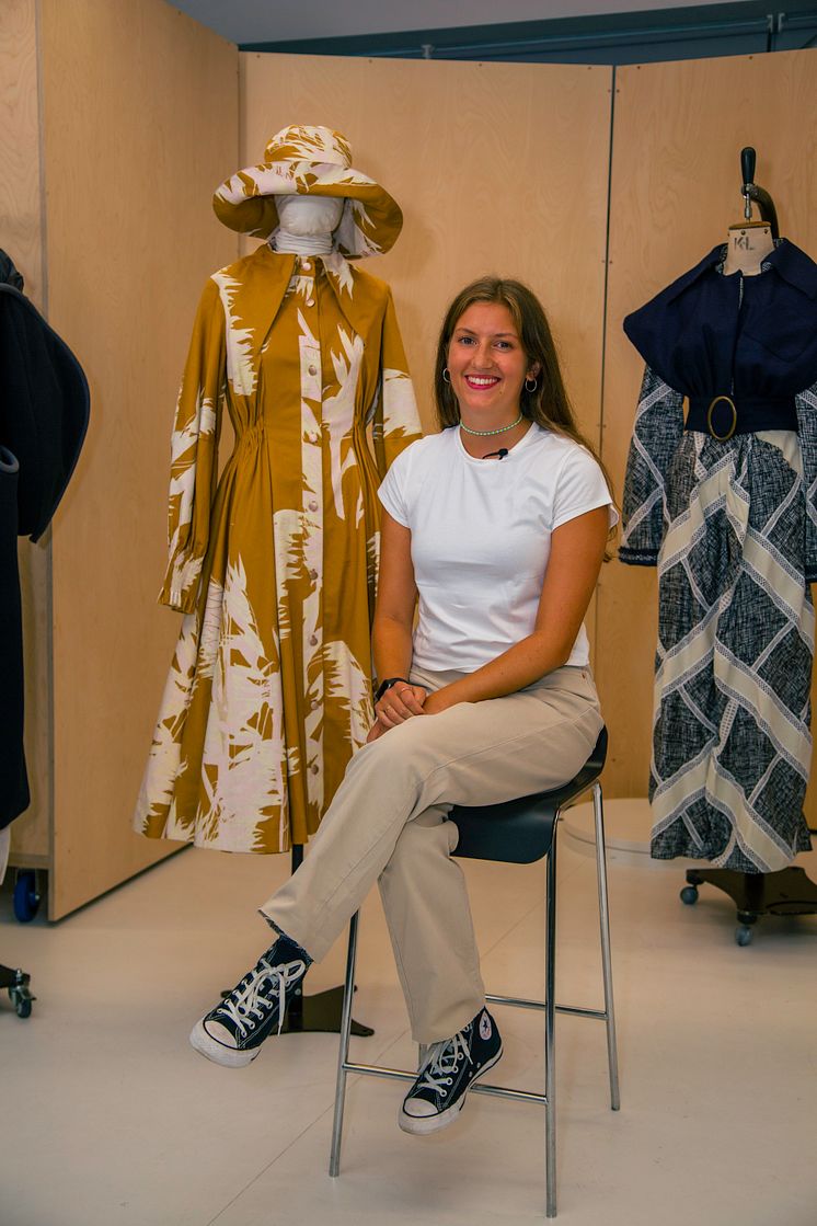 Fashion graduate Holly Hooker with her yellow outfit inspired by traditional smock frocks