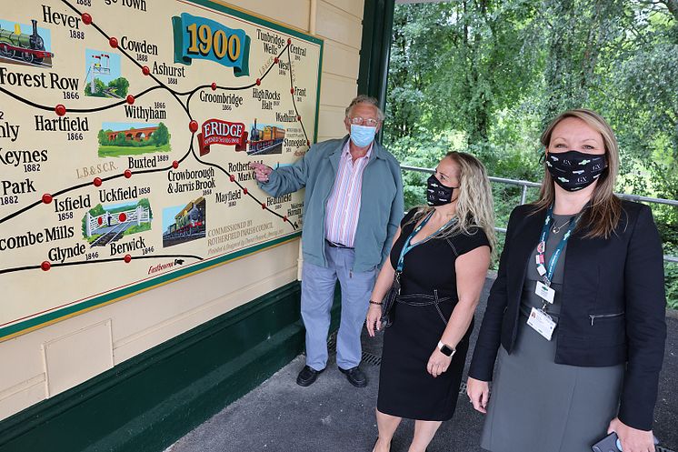 Mural artist David Peacock with his railway map at Eridge station