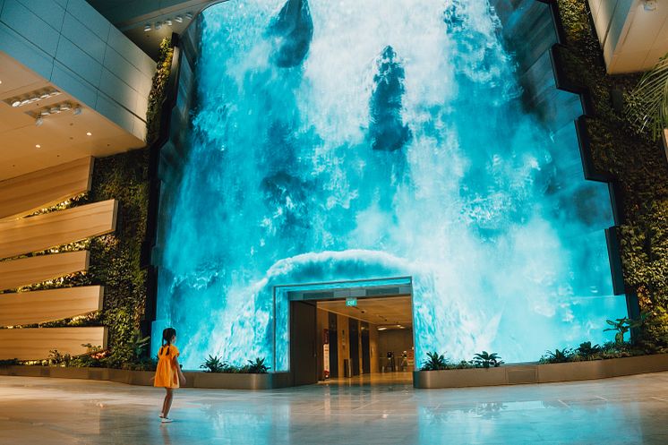 Be transported to a captivating realm as a grand digital waterfall descends at T2's departure hall