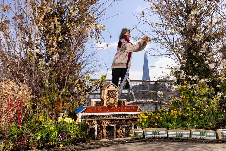 Alice McCabe puts the finishing touches to the living art installation