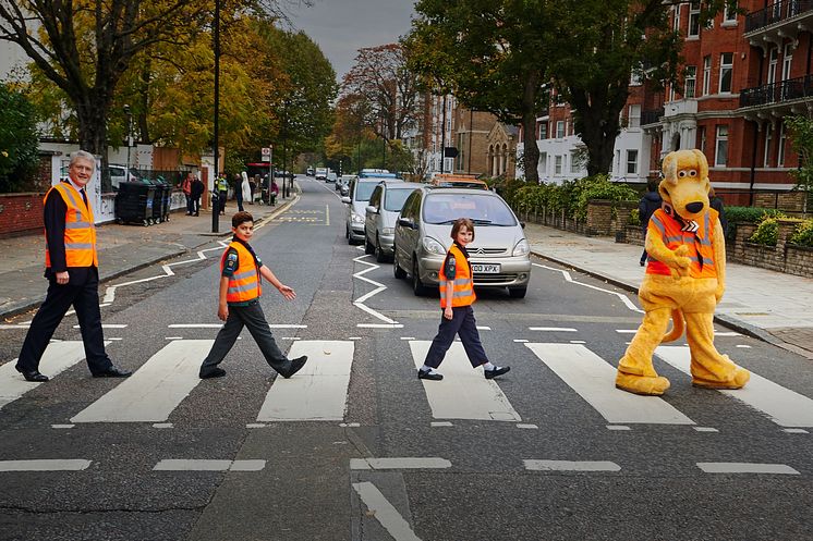 The road safety minister, two Cub Scouts and road safety mascot Horace recreate the famous Beatles album cover at the zebra crossing on Abbey Road