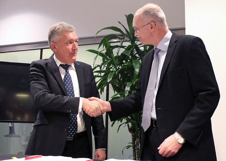 Rektor på DTU Anders Overgaard Bjarklev og Regionsdirektør i Forenede Service Jan Jeppesen lykønsker hinanden med aftalen