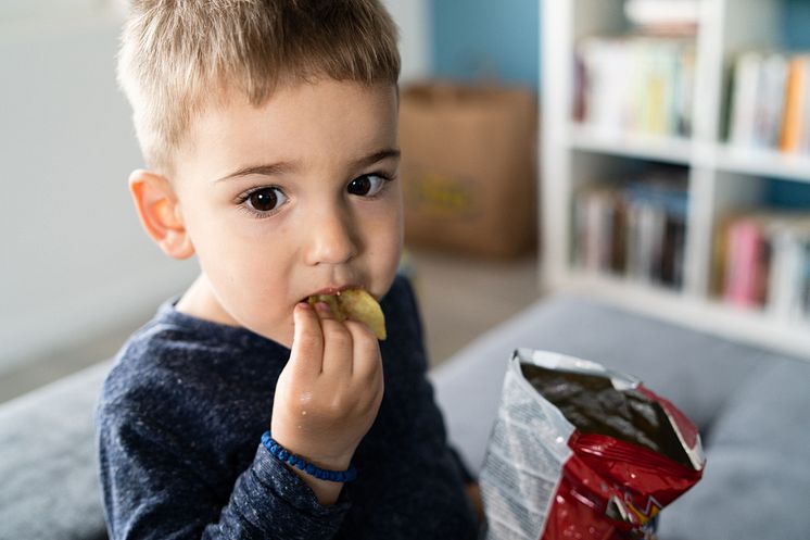 Child eating unhealthy snacks.jpg