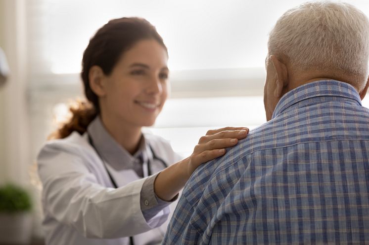 46333464-close-up-smiling-female-doctor-touching-old-patient