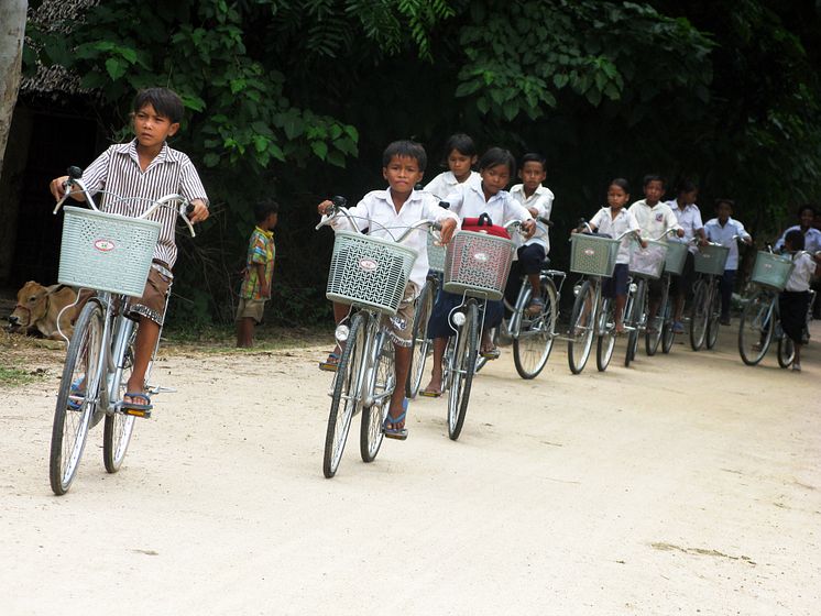 Kambodjanska skolbarn på cykel