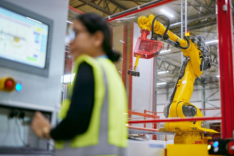 Employee working on a machine (photo DHL).jpeg