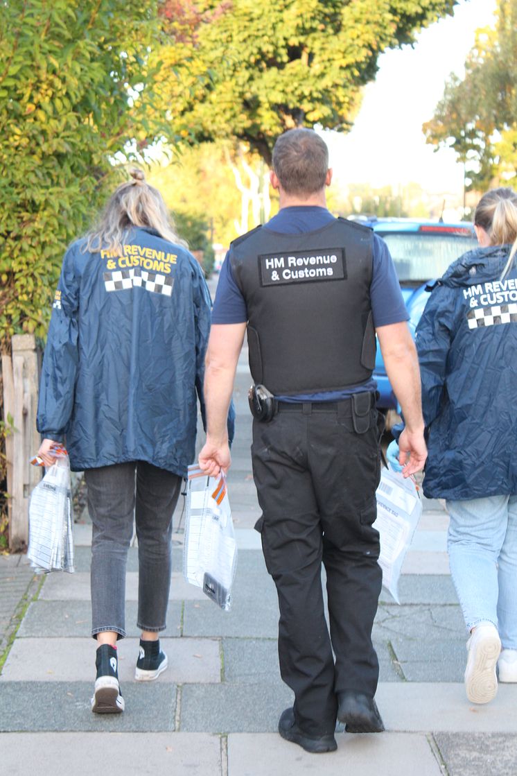 HMRC officers with seized evidence, following a coordinated operation across England into large-scale tax repayment fraud