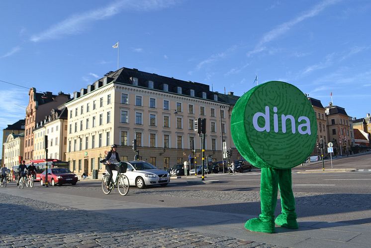 Dina Försäkringars maskot framför Dina Försäkringars fastighet på Skeppsbron i Stockholm