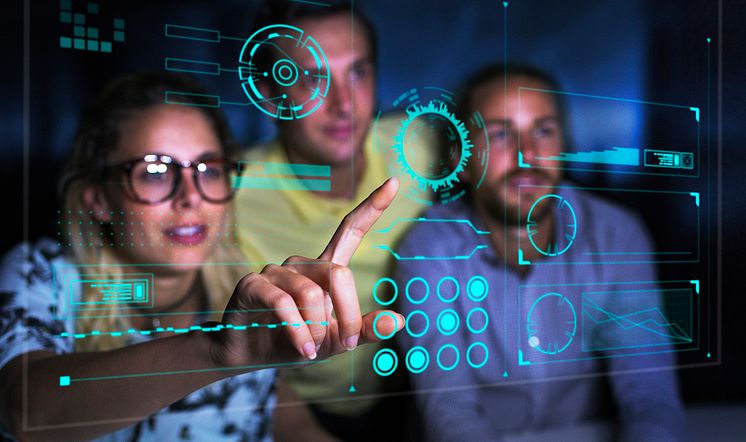 Computer programmers examining data on futuristic screen_CaiaImage_GettyImages-956550414 (1)