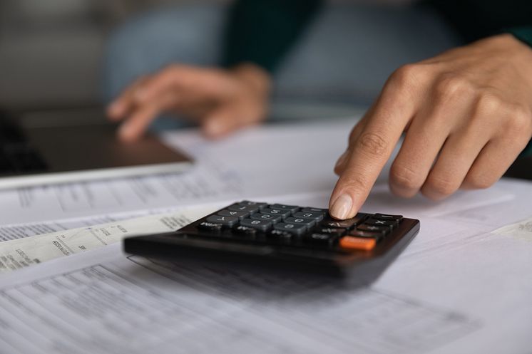 53432154-close-up-young-woman-using-calculator-managing-budget.jpg