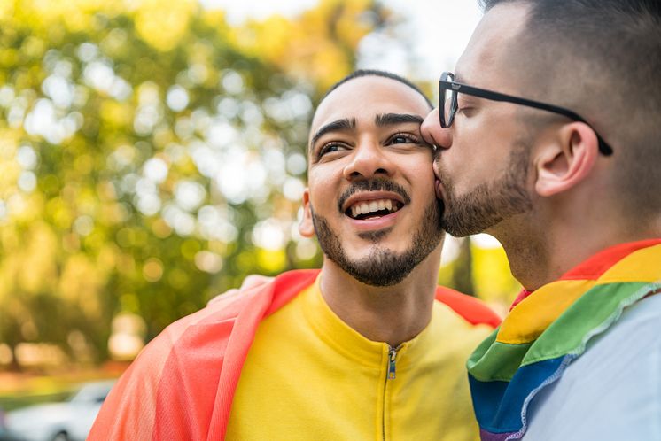 37801730-gay-couple-embracing-and-showing-their-love-with-rainbow.jpg