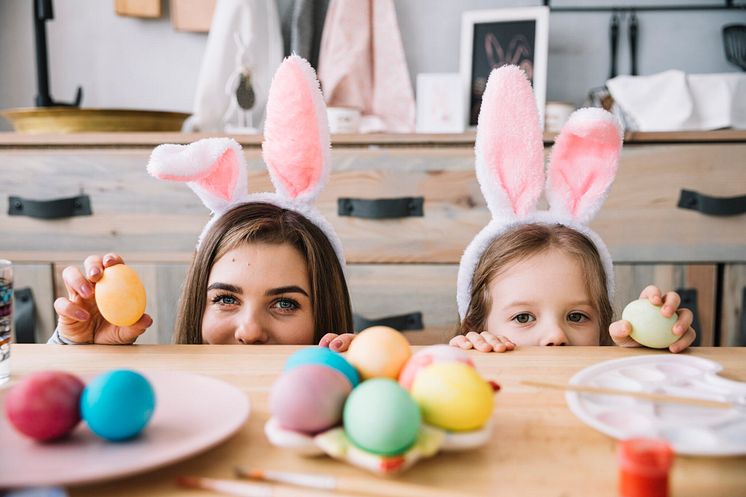 little-girl-mother-bunny-ears-hiding-table-with-colored-eggs-2048x1365.jpg