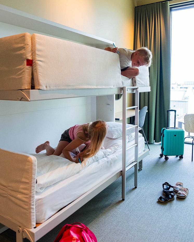 Children getting comfortable in bunk beds at Citybox Kristiansand