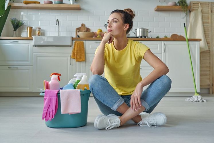 thoughtful-young-woman-sitting-near-bucket-with-cleaning-stuff-domestic-kitchen.jpg