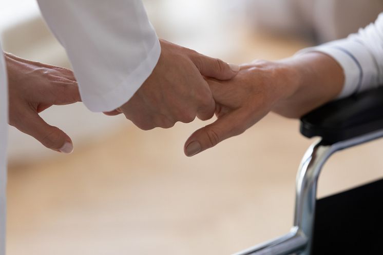 35563880-close-up-caregiver-holding-disabled-older-woman-hand