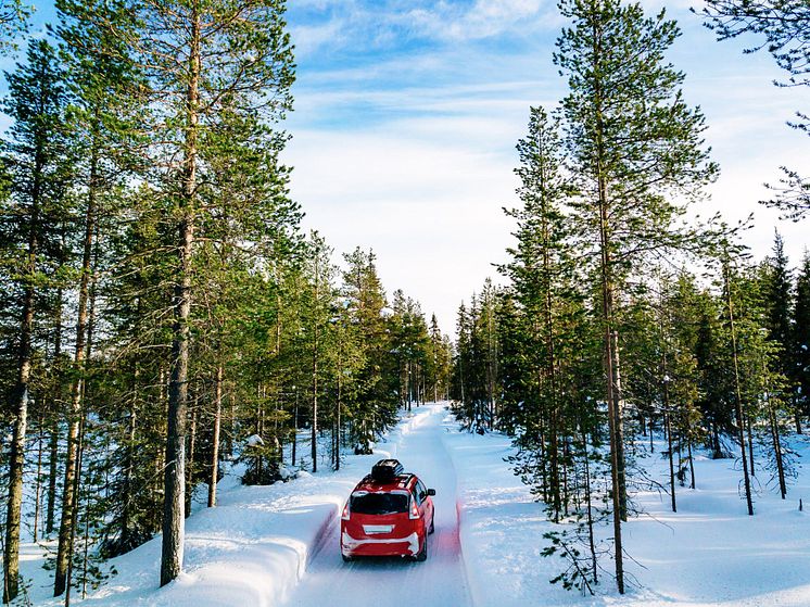 red-car-with-roof-rack-driving-on-snow-forest-road-2021-08-27-09-56-07-utc (2).jpg