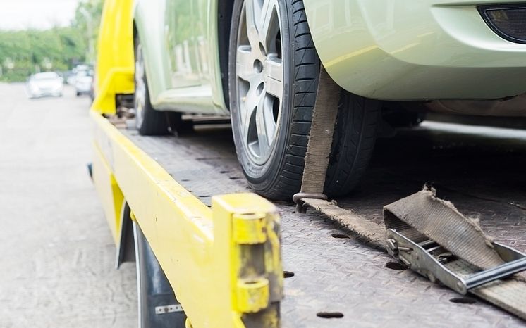car-transporter-breakdown-lorry-working-using-locked-belt-transport-other-green-car.jpg