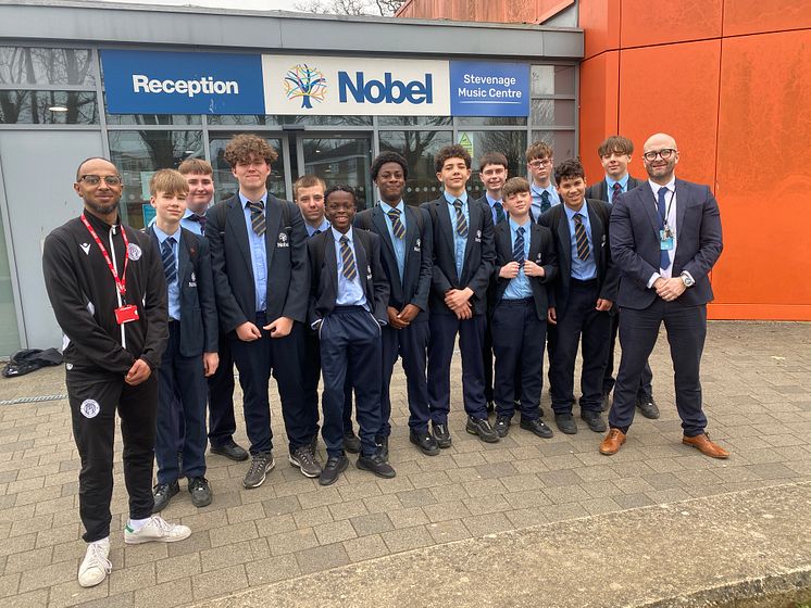 Lewis Sykes (far left) of Stevenage Football Club Foundation and Danny Camp (far right), Director of Alternative Provision with Step Up students at The Nobel School.JPG