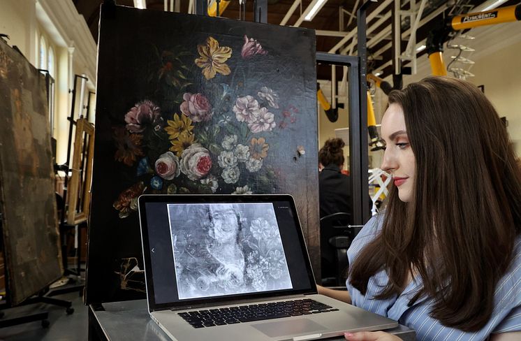 Student Elliot Keim with the painting she X-rayed using the new machine and the image discovered underneath.jpg